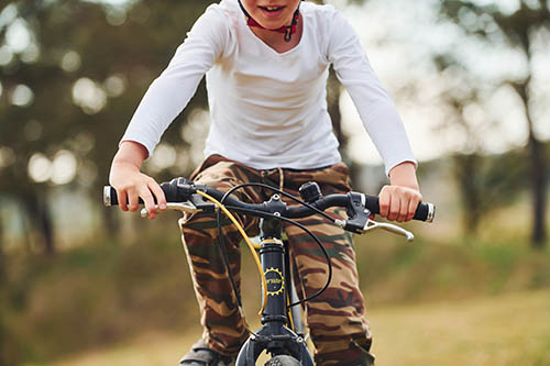 Young boy riding his bike outdoors